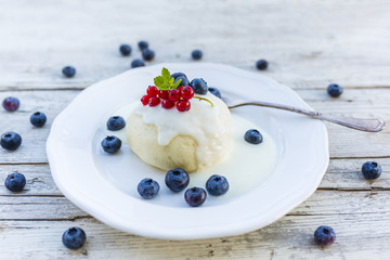A delicious dessert with steamed dumpling and freshly picked fruits.