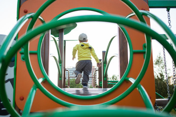 Little boy playing on the playground.
