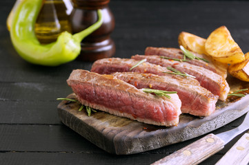 medium-roasted meat on the grill. on black background.