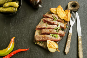 medium-roasted meat on the grill. on black background.
