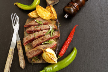 medium-roasted meat on the grill. on black background.