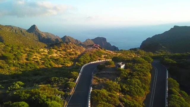 View from the height of the rocks, winding road and ocean in the distance in the Masca at sunset, Tenerife, Canary Islands, Spain.