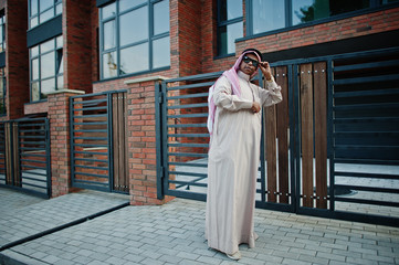 Fototapeta na wymiar Middle Eastern arab business man posed on street against modern building with sunglasses.