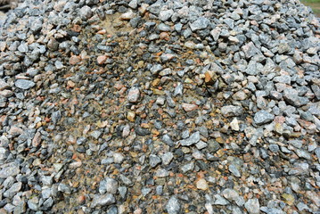 Building materials and fettling background, light crushed stone after rain