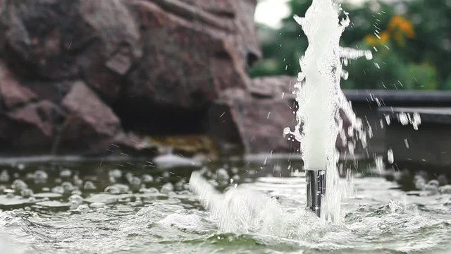 Water flow fling or Shoot up, Fountain splash. Water pressure. Fountain in summer park. Splashing streams fountain. Strong spray of fountain water, close up.
