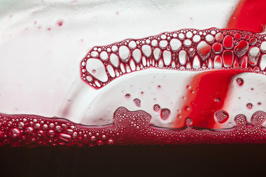 cliseup of red juice's froth