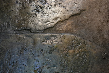 Building materials, wet concrete asphalt old after a rainstorm very bright brown background