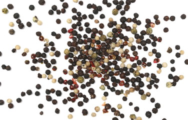 Colorful and unground mixed pepper pile isolated on white background, top view