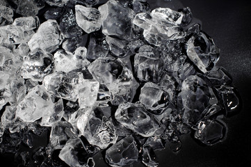 Textured background of a small ice cubes on the dark background
