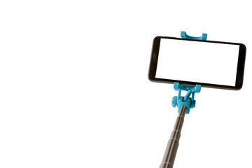 Monopod for selfie with smart phone. Selfie stick with smartphone isolated on white background