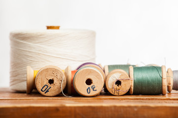 Sewing on the background of the old wooden walls