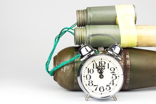 Timed bomb. Old alarm clock with a bomb. Danger of explosion. The concept of terrorism.