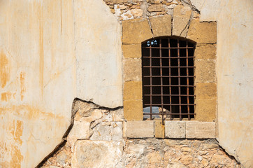 Fototapeta na wymiar Metallic open window on a yellow grungy wall