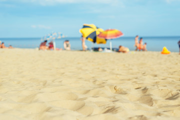 sand beach closeup with umbrellas near sea