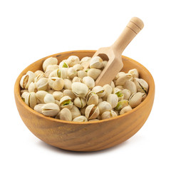 Pistachios nuts in wooden bowl isolated on a white background