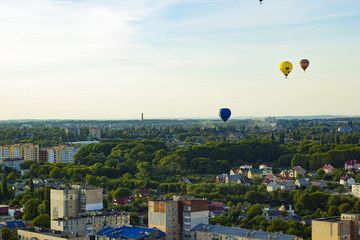 Flight of large air balloons over city