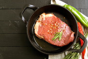 Raw meat. Raw beef steak on cutting Board and spices.