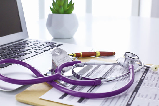 Doctor's workspace working table with patient's discharge blank