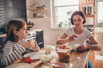 Mother and daughter having a breakfast