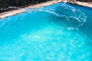 splashing of disinfectant in outdoor swimming pool