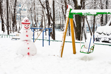 snowman at public playground in winter
