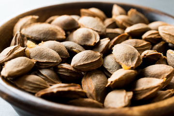 Dried Apricot Kernels in Wooden Bowl.