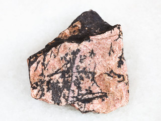 rough Rhodonite stone on white