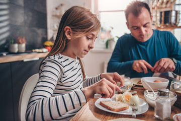 Father and daughter having breakfast