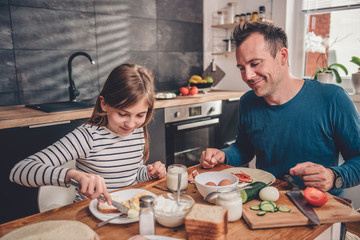 Father and daughter having breakfast