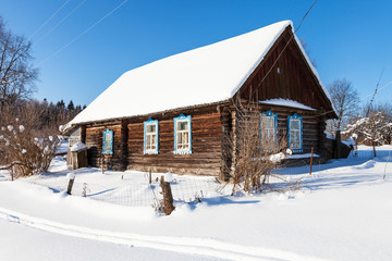 old typical rural house in sunny winter day