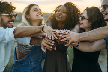 Friends holding hands together