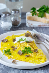 Omelette with truffle and parsley, served with sour cream, bread and a glass of fresh water.