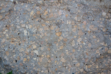 The texture of a gray stone with yellow impregnations