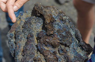 Nephelinite volcanic rock in the hands.