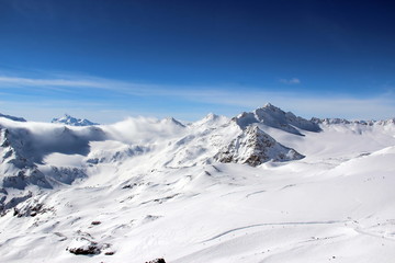 Snowy Mountains in the clouds blue sky Caucasus Elbrus