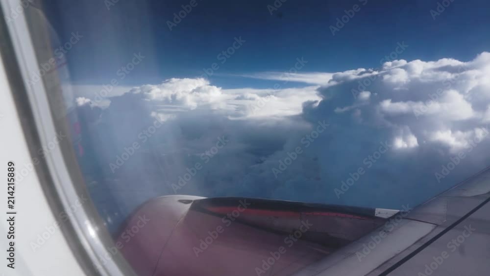 Aufkleber view of red airplane engine during flight with slow clouds moving in the background
