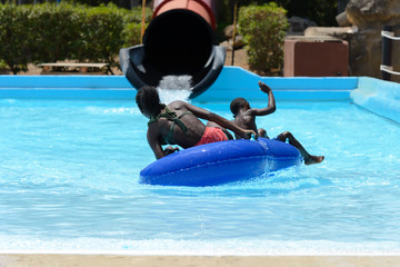 people ride water slides in the water park