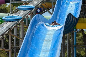 people ride water slides in the water park