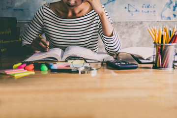 Young student sitting at desk in home studying and reading, doing homework and lesson practice preparing exam to entrance, education concept