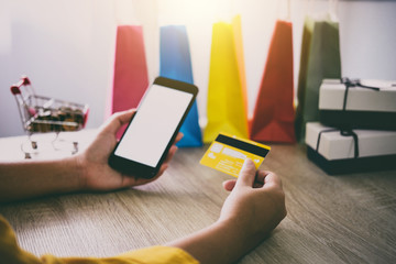 Image of Young woman using smartphone for online shopping website and pay by credit card, Online payment and shopping concept
