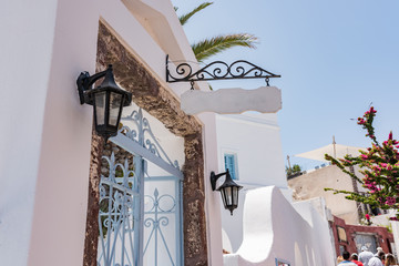 Entrance to courtyard of the house with lovely lanterns in the Oia village on the Thira island, Greece.