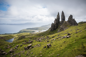 Fototapeta na wymiar Old Man of Storr on the Isle of Skye with a sea in the background during a cloudy summer day in Scotland