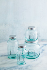 Glass jars, ready for sterilization and canning. preservation of food on a marble table.