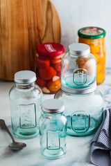 Glass jars, ready for sterilization and canning. preservation of food on a marble table.