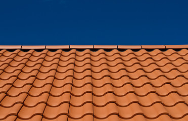 House roof with new tiles. Tile roof and blue sky