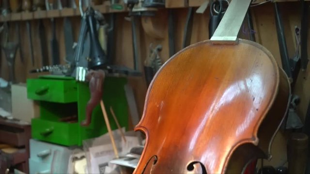 Hands of an artisan Italian luthier wood carver at work