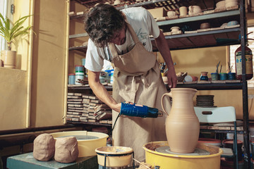 Creating a jar or vase of white clay close-up. Master crock.
