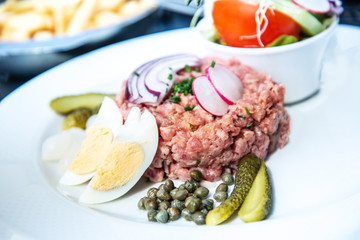 tasty Steak tartare (Raw beef) - classic steak tartare on white plate