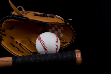 Baseball bat, ball and glove on black