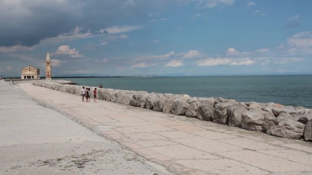 Caorle, Promenade of with tourists on walks